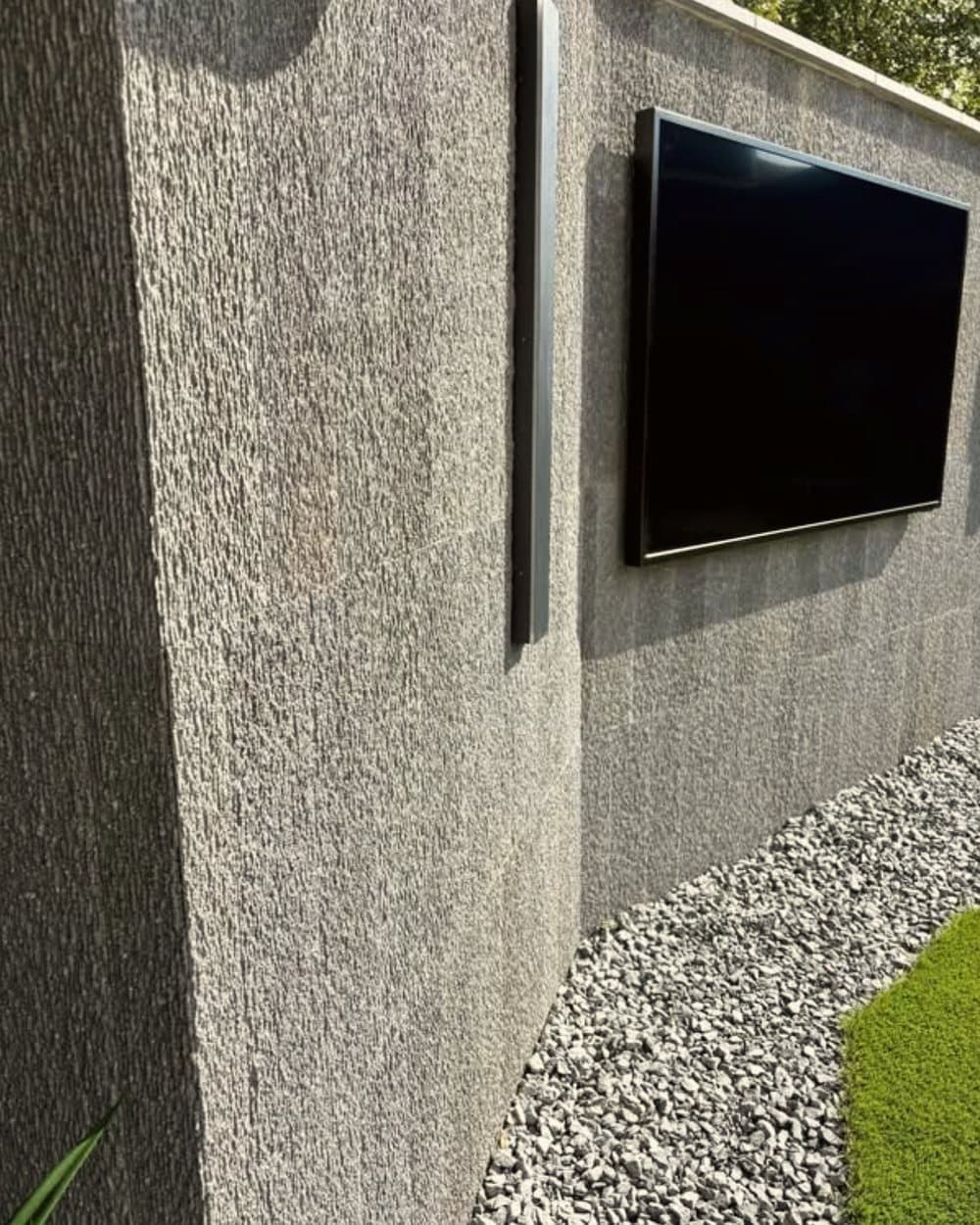 Textured stone feature wall with mounted TV